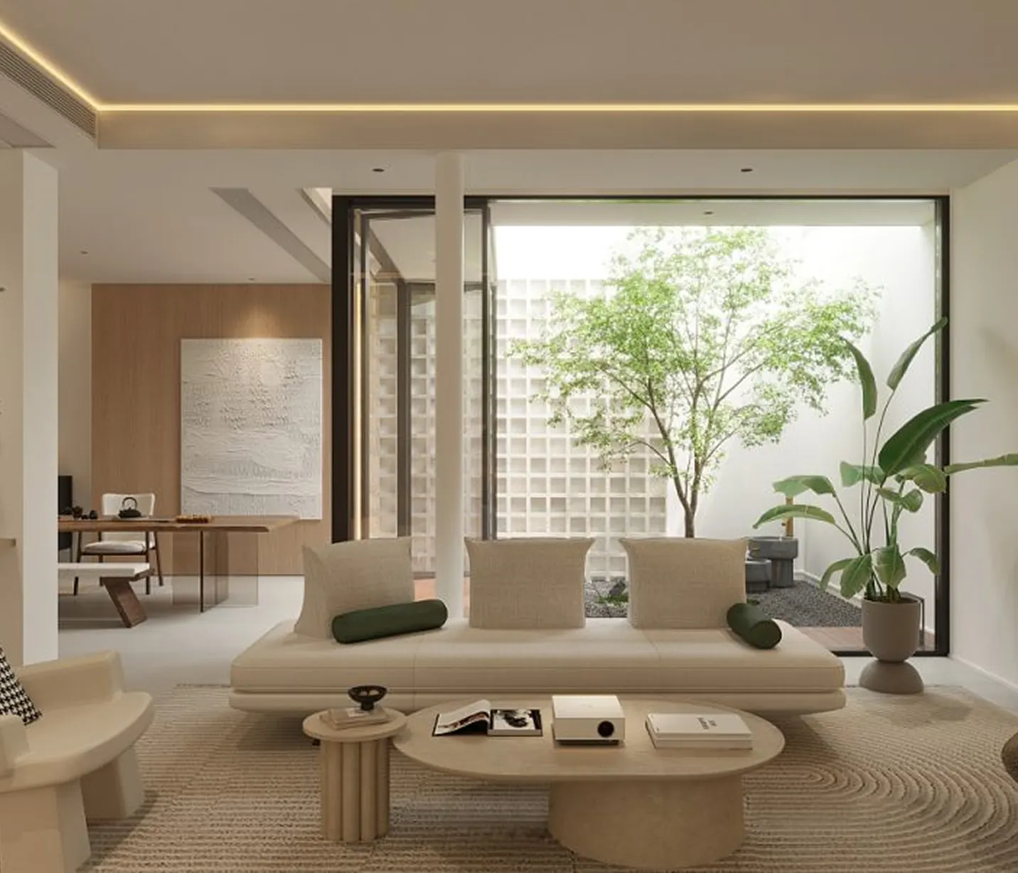 Minimalist living room with a beige sofa, green cylindrical pillows, round coffee table, potted plants, and large glass window overlooking an outdoor tree.